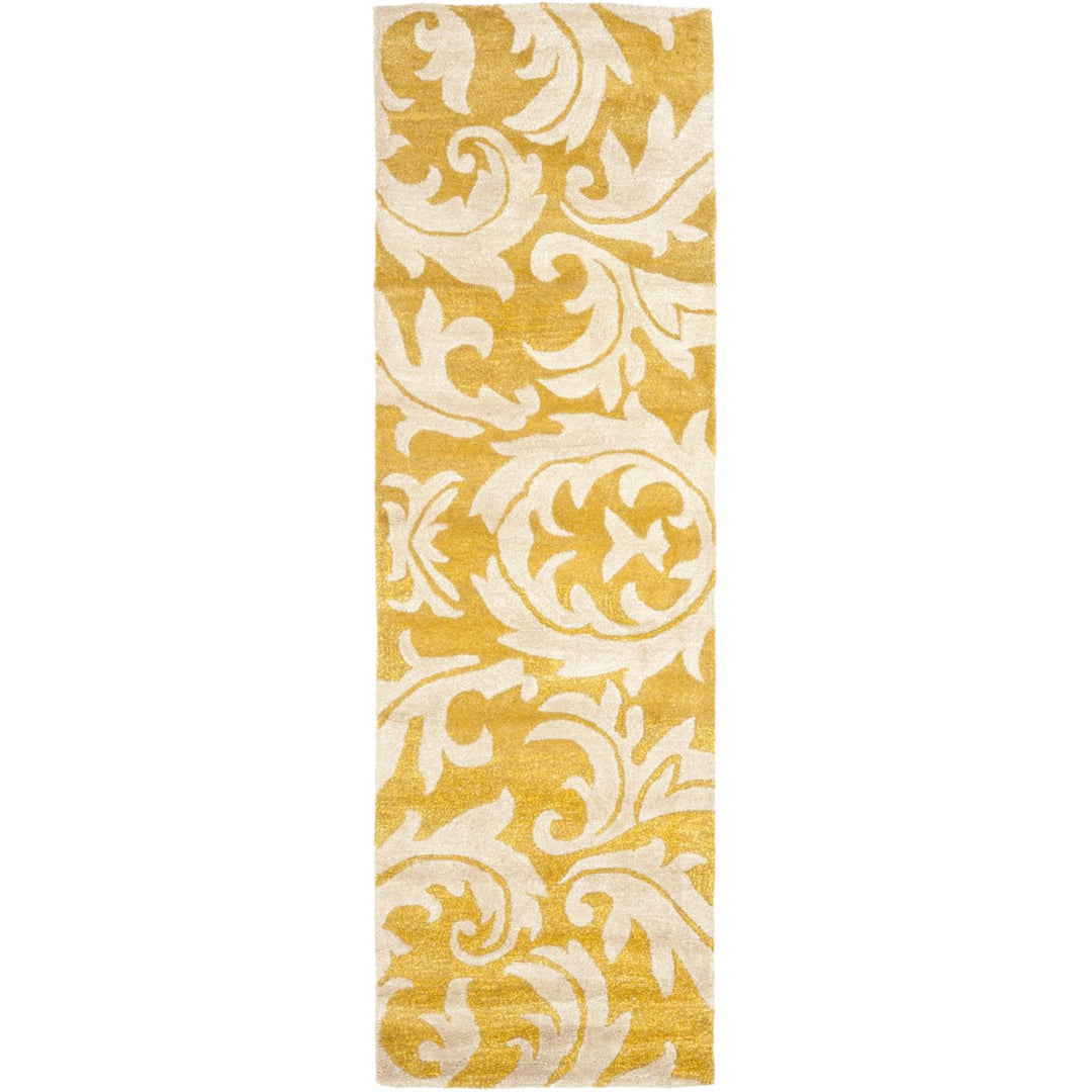 SAFAVIEH Soho Collection SOH841A Handmade Gold/Ivory Rug Image 1