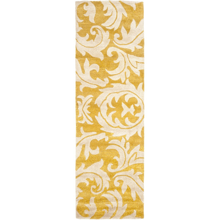 SAFAVIEH Soho Collection SOH841A Handmade Gold/Ivory Rug Image 1