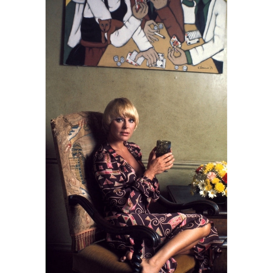 Elke Sommer - Sitting on Chair Holding a Glass Photo Print (8 x 10) - Item DAP18072 Image 1