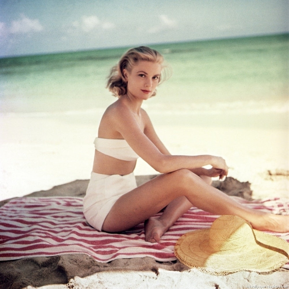 Grace Kelly - Sitting on Stirped Towel in White Bikini Photo Print (8 x 10) - Item DAP18246 Image 1