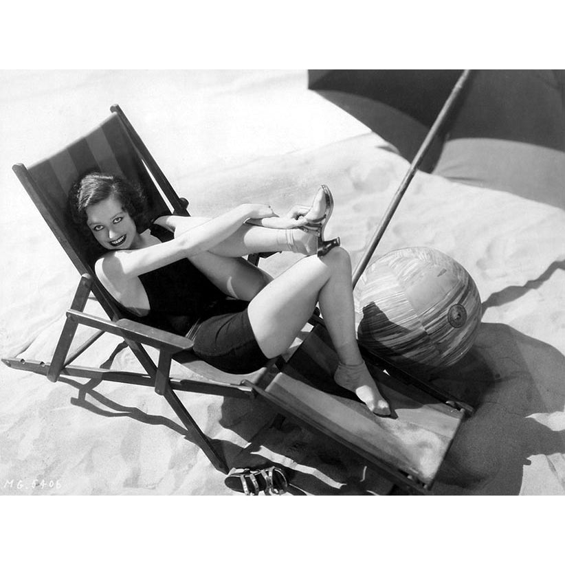 Joan Crawford - Laying with Foot Up on Beach Lounger Photo Print (10 x 8) - Item DAP18715 Image 1