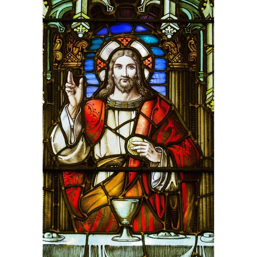 Close up of stain glass window with Jesus Christ at a table with chalice and holding bread; Calgary Alberta Canada Image 1