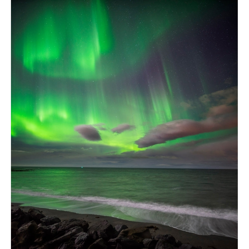 Northern lights over the waves breakiing on the beach in Seltjarnarnes Reykjavik Iceland Poster Print (8 x 10) Image 1