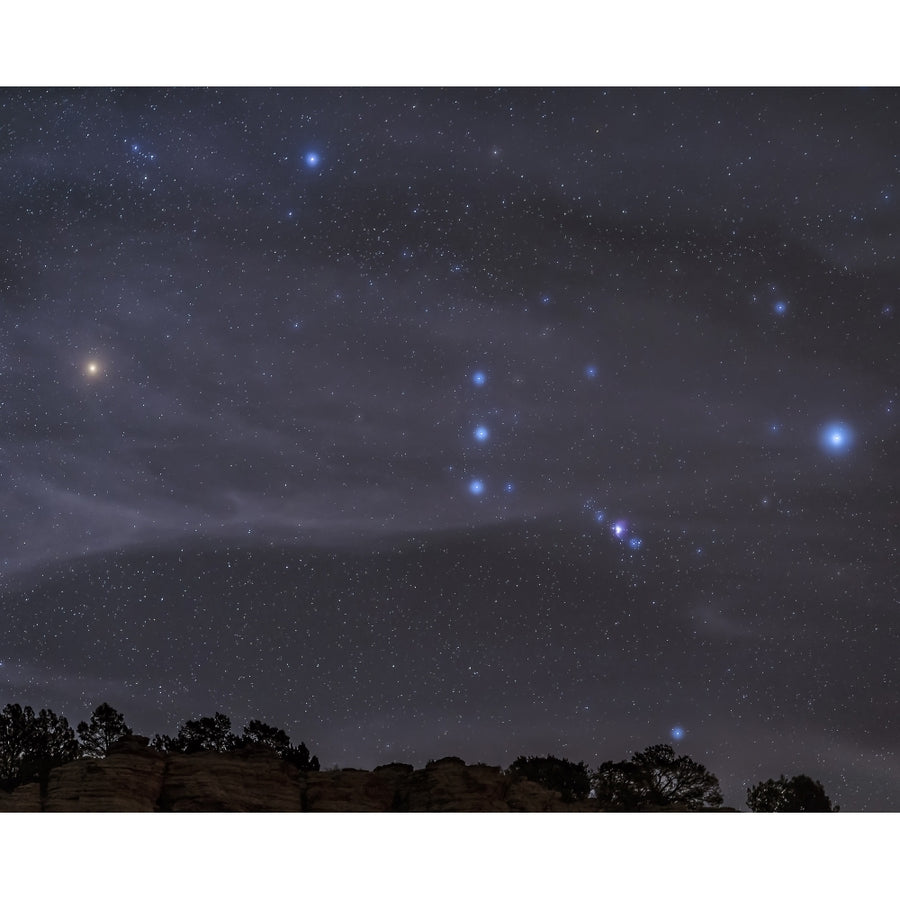 The Orion constellation rises over a hill through high thin clouds Poster Print (8 x 10) Image 1