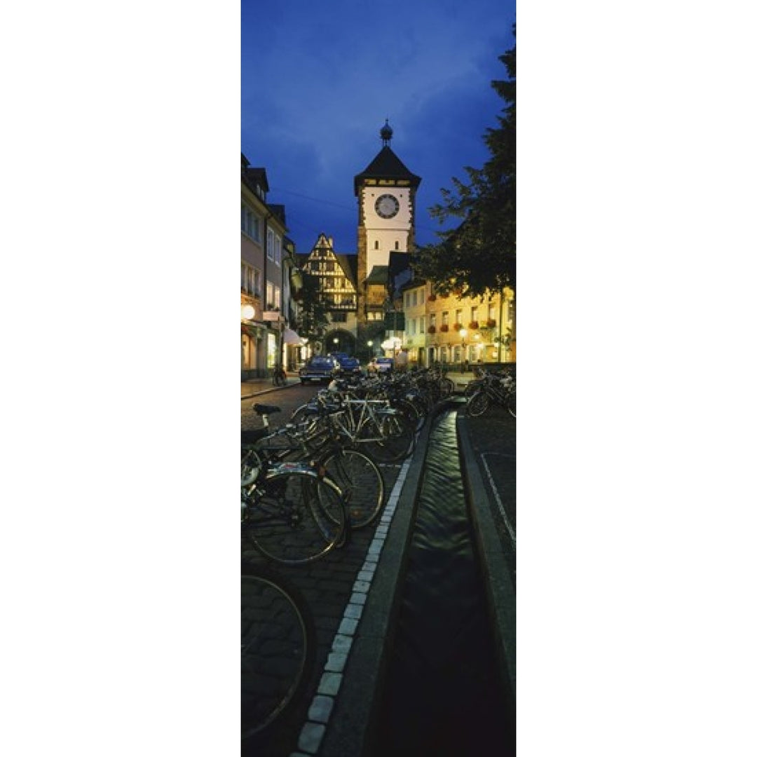 Bicycles parked along a stream near a road Freiburg Baden-Wurttemberg Germany Poster Print (36 x 13) Image 1