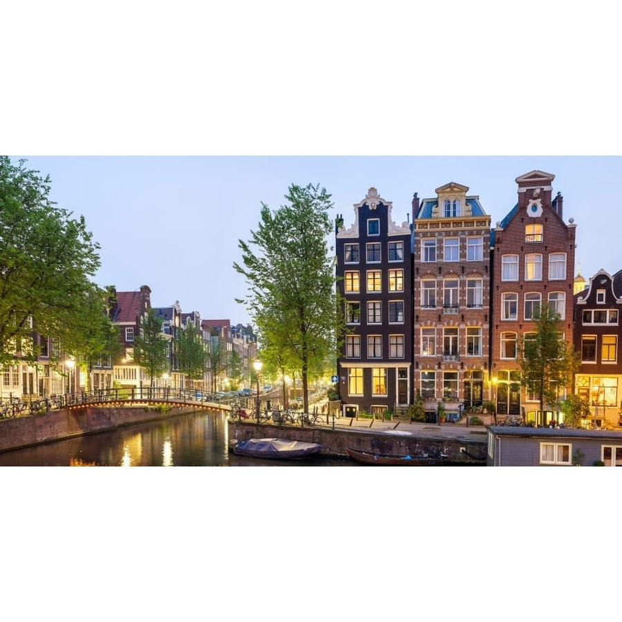 Houses along canal at dusk at intersection of Herengracht and Brouwersgracht Amsterdam North Holland Netherlands 12 x 36 Image 1