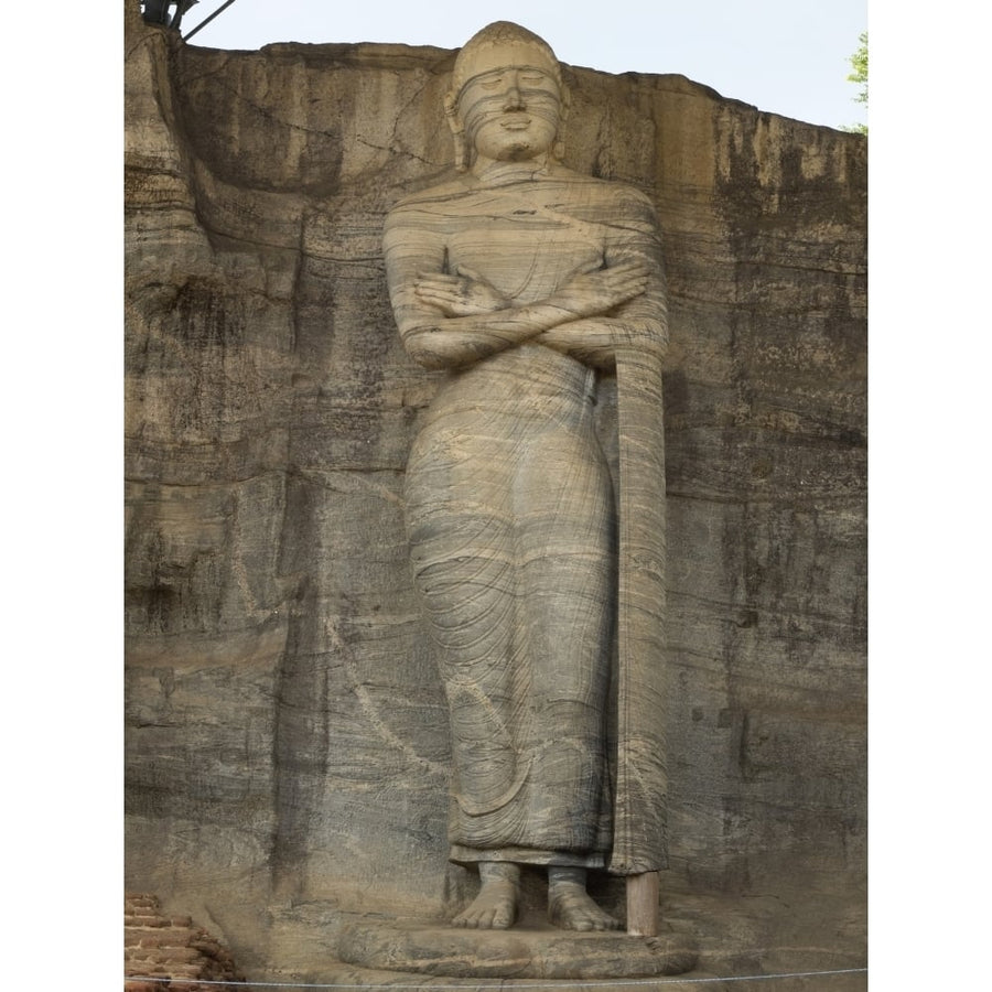 Standing Buddha figure depicts an unusual mudra carved from single rock face at Image 1