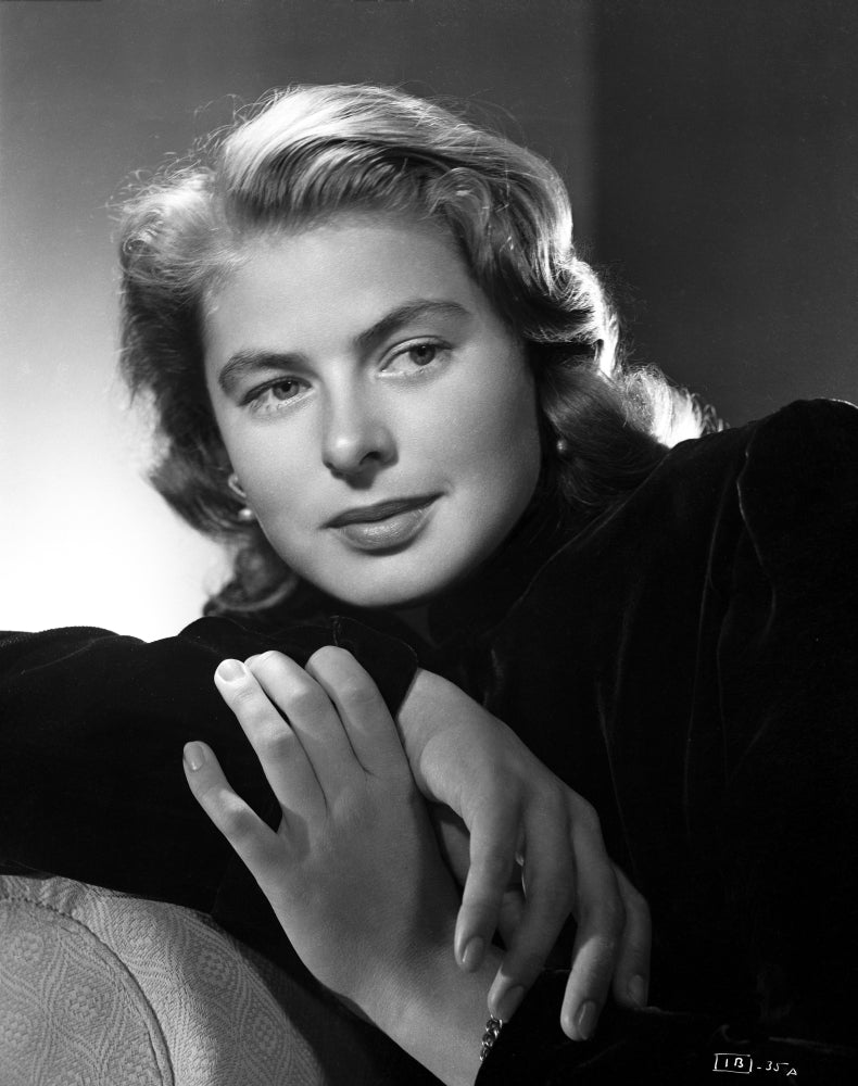 Ingrid Bergman sitting and Leaning on a Couch in a Black Long Sleeve Polo Photo Print Image 1