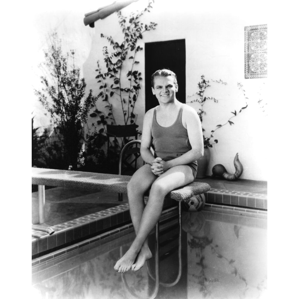 James Cagney wearing a bathing suit sitting on a diving board Photo Print Image 1