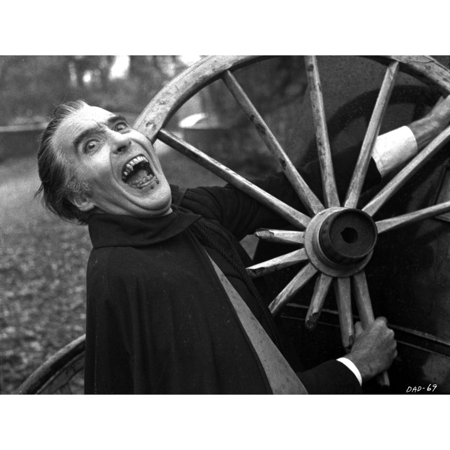 Film still of Christopher Lee as Dracula next to a wagon wheel Photo Print Image 1