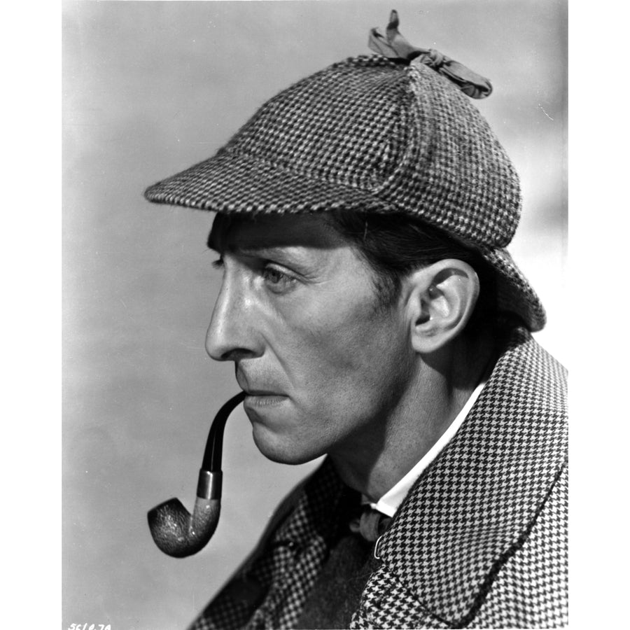 Peter Cushing wearing a detectives costume and smoking a pipe Photo Print Image 1