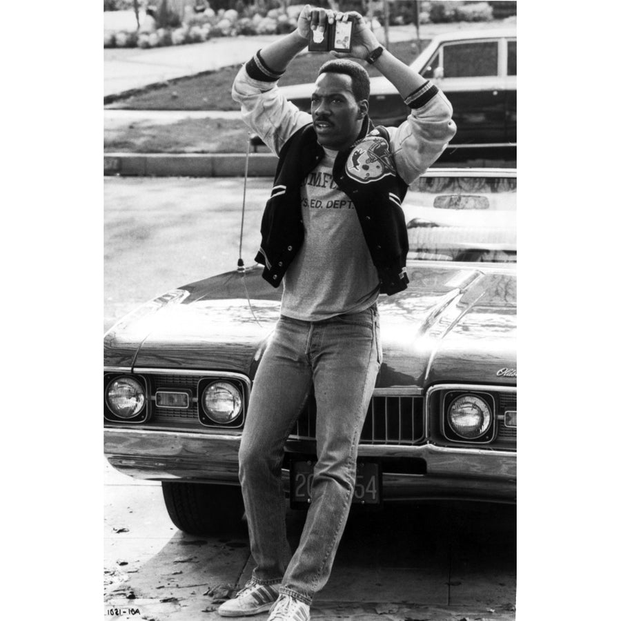 Eddie Murphy holding up a police badge Photo Print Image 1