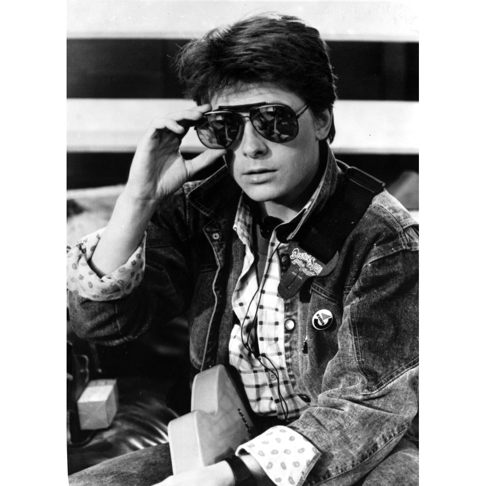 Michael J Fox wearing aviator sunglasses and a denim jacket Photo Print Image 1