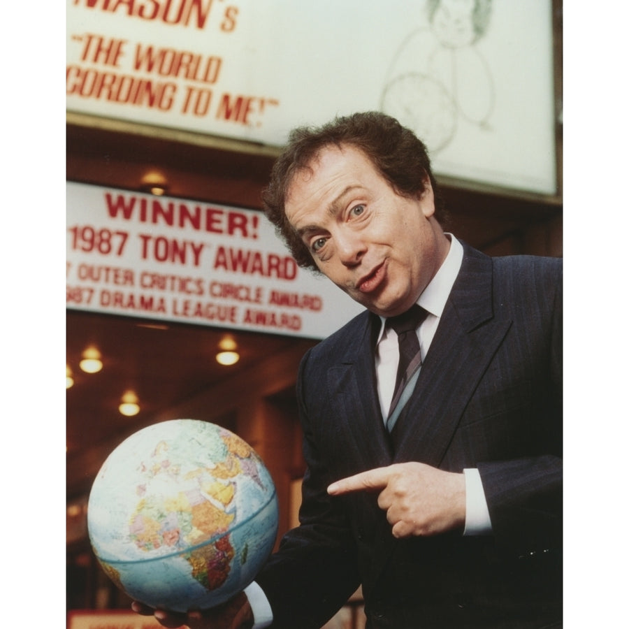 Jackie Mason wearing a Suit and Tie Pointing a Globe Photo Print Image 1