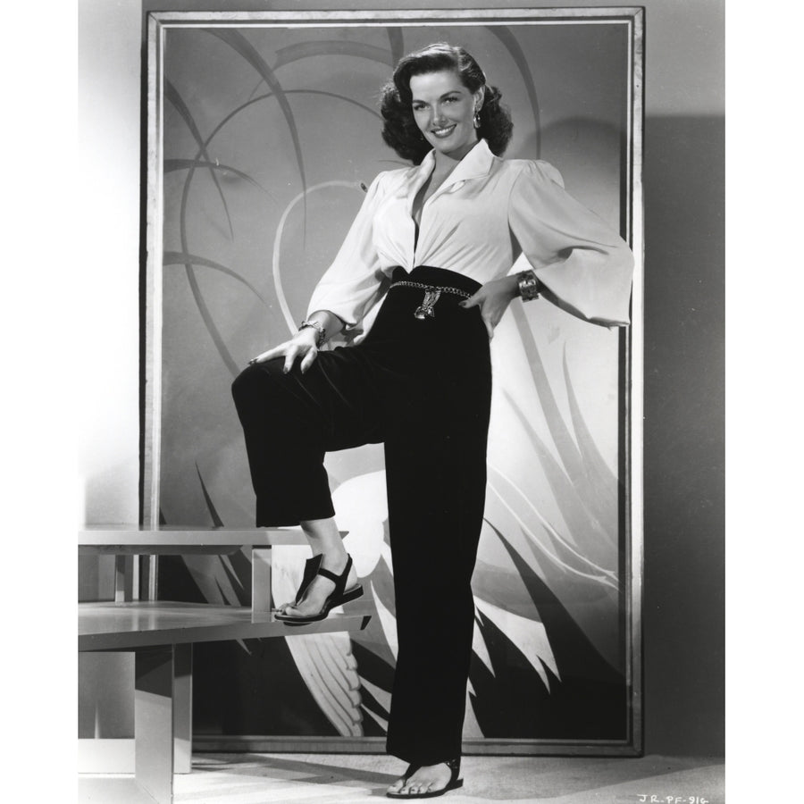 Jane Russell Posed in White Tucked-On V-Neck Long Sleeve Shirt and High Waist Linen Pants with Right Foot on the Stair Image 1