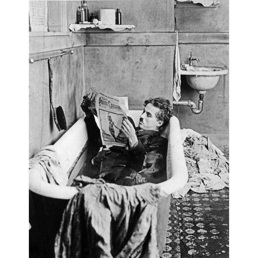 A film still of Charlie Chaplin reading a newspaper in a bathtub Photo Print Image 1