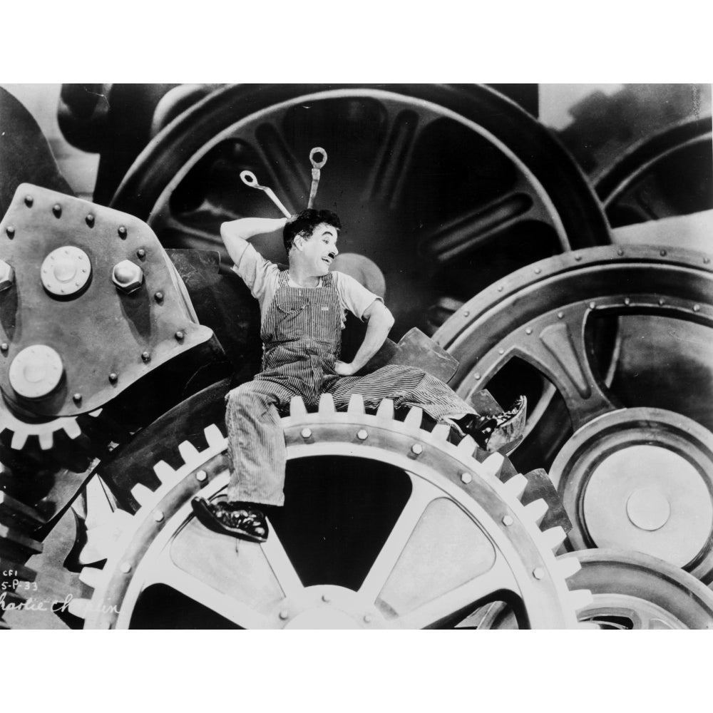 A film still of Charlie Chaplin inside a machine from Modern Times Photo Print Image 1