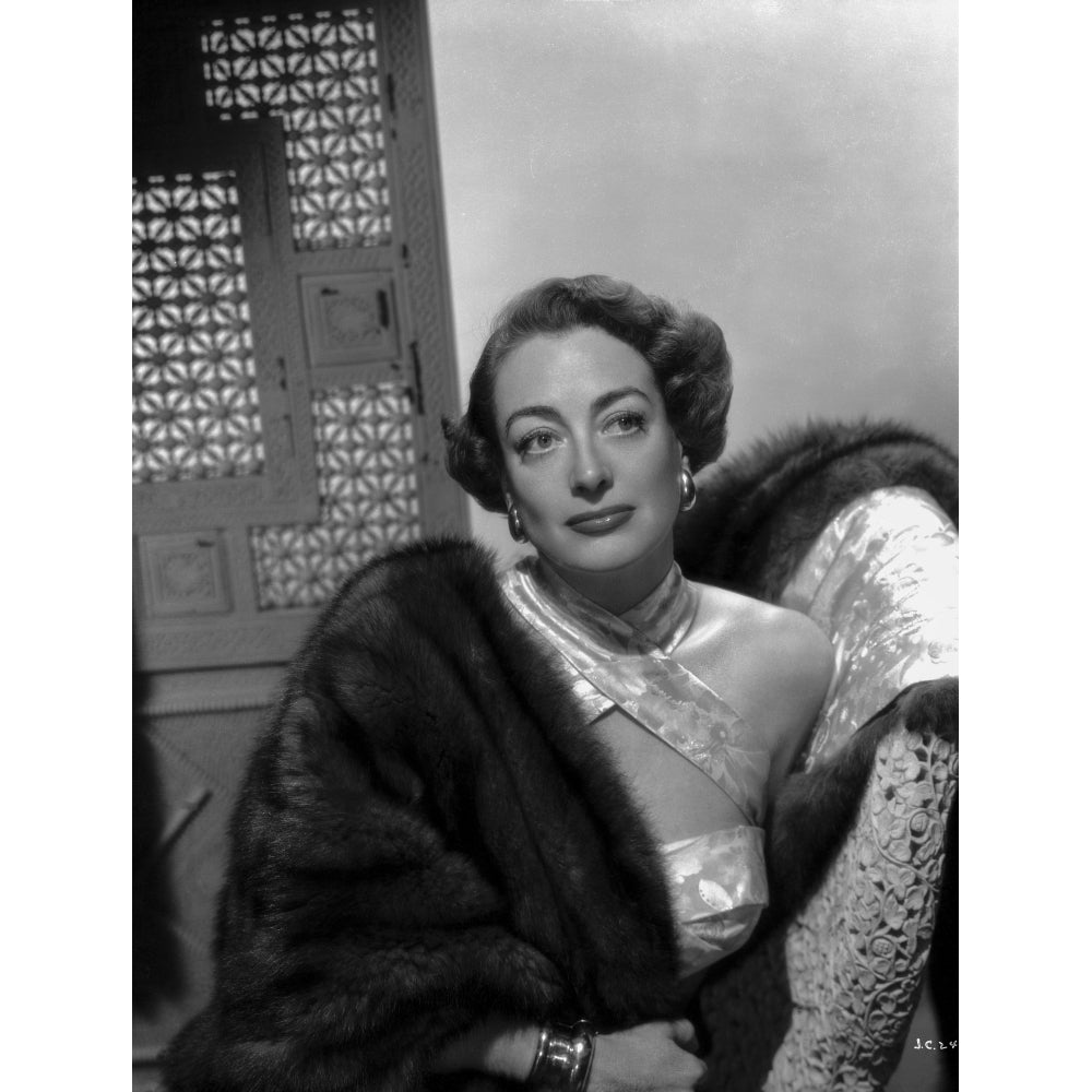 Joan Crawford Looking Away From the Camera while Leaning on a Chair in Classic Photo Print Image 1