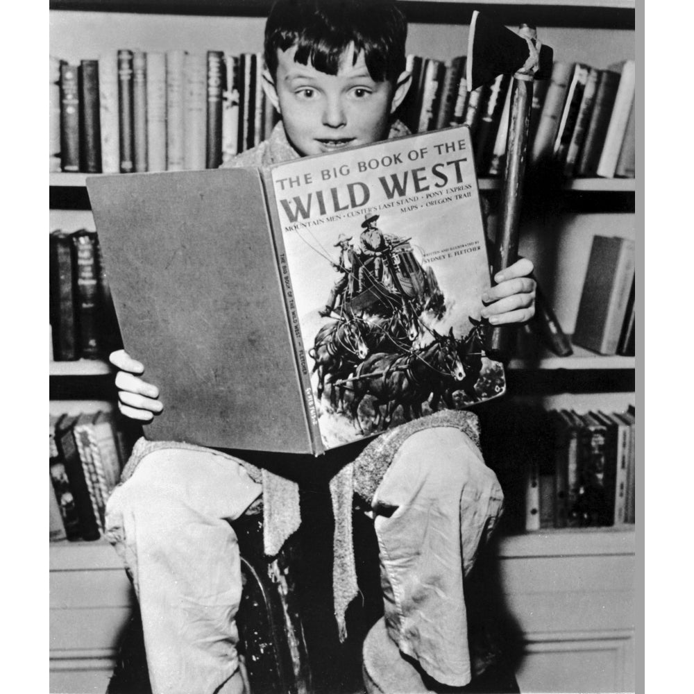 A film still from Leave It To Beaver with a boy reading a book Photo Print Image 1