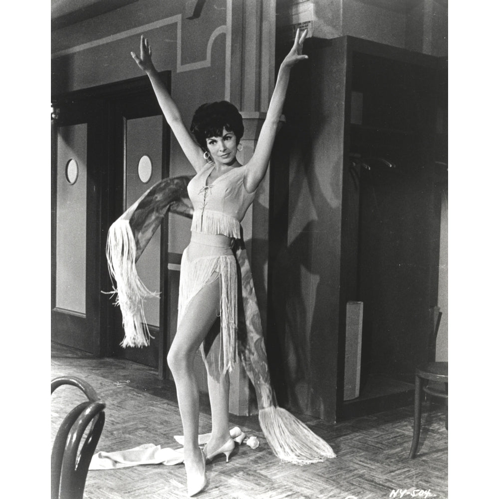 Janet Leigh Posed in White Silk V-Neck Gathered Bodice Sleeveless Dress with Right Foot Forward and Hands Raised Up to Image 1