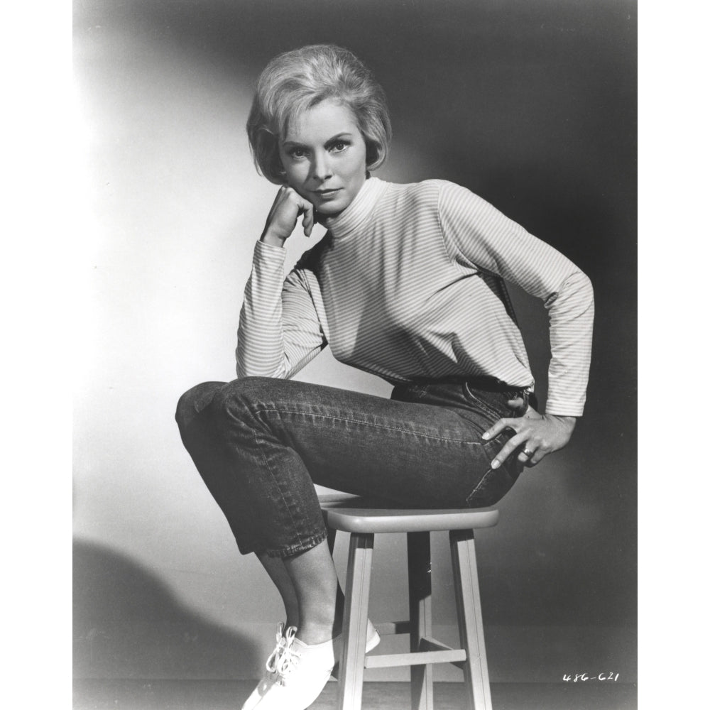 Janet Leigh sitting on a Chiar in White High Neck Long Sleeve Linen Dress with Knees Bent and Head Leaning on the Right Image 1