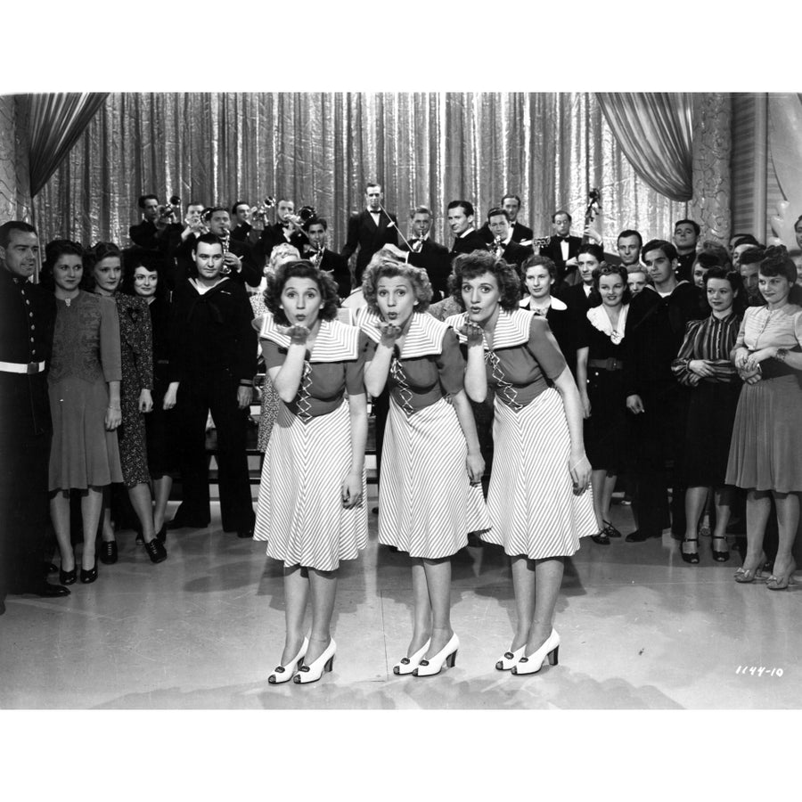 The Andrew Sisters in uniform blowing kisses during a performance Photo Print Image 1