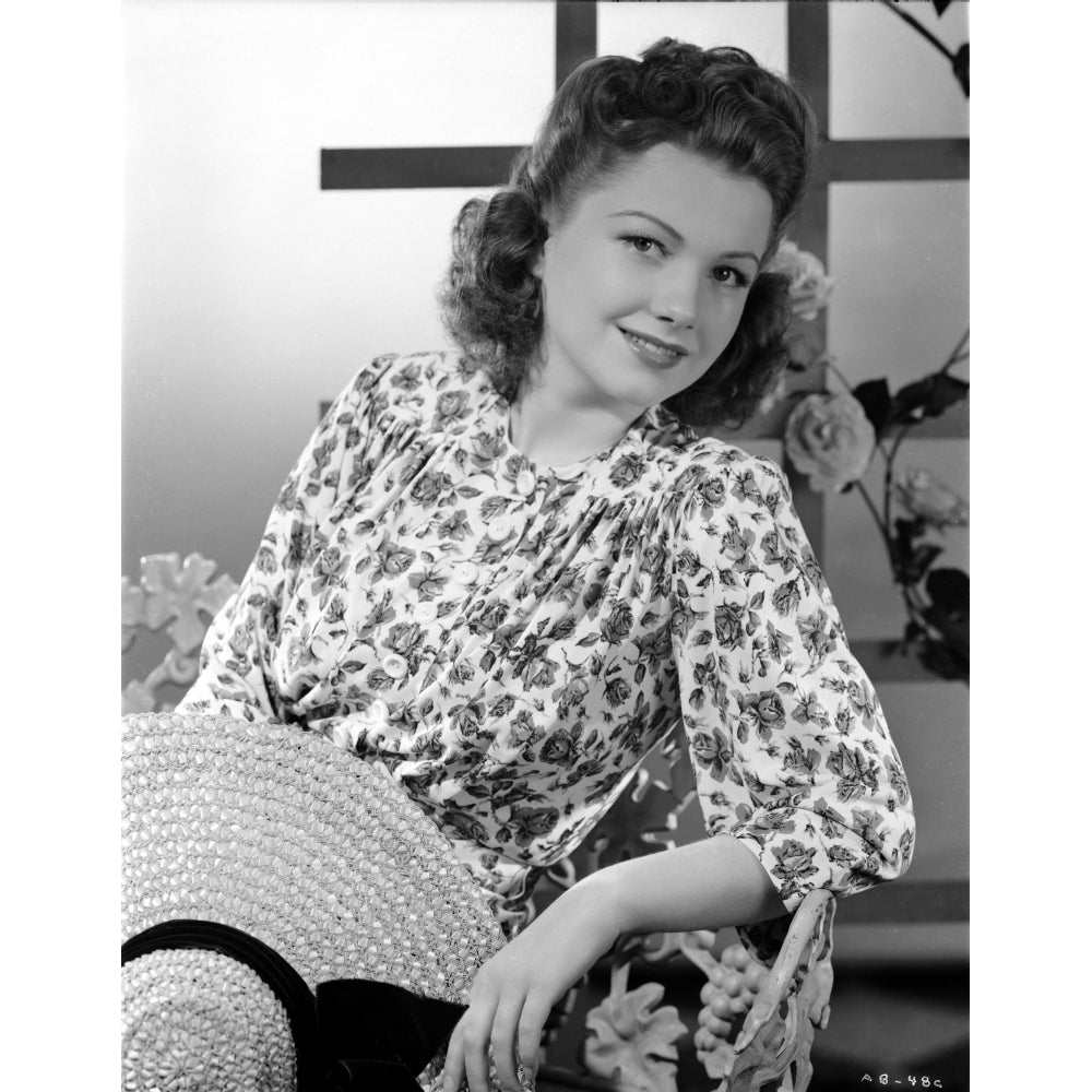 Anne Baxter posed on Floral Dress sitting and smiling Photo Print Image 1