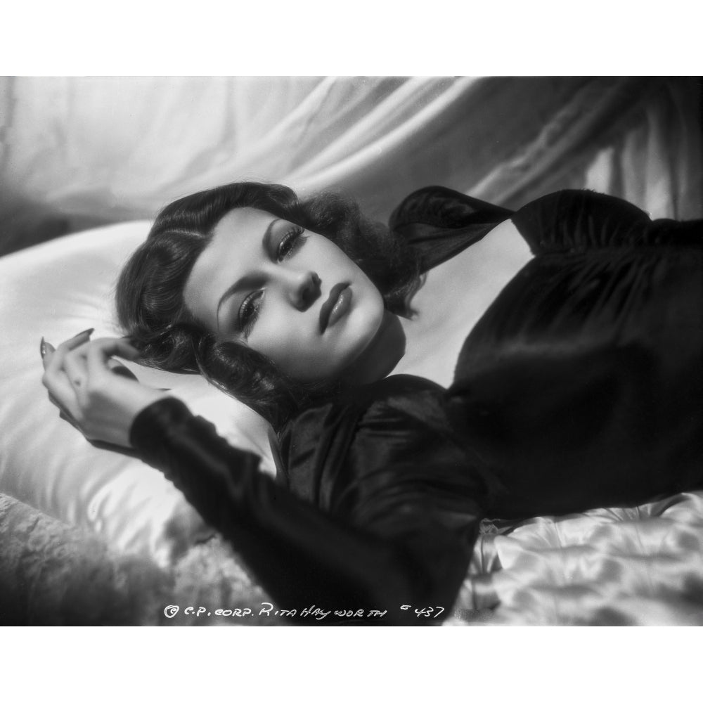 Rita Hayworth Lying on Bed in Black Gown Photo Print Image 1