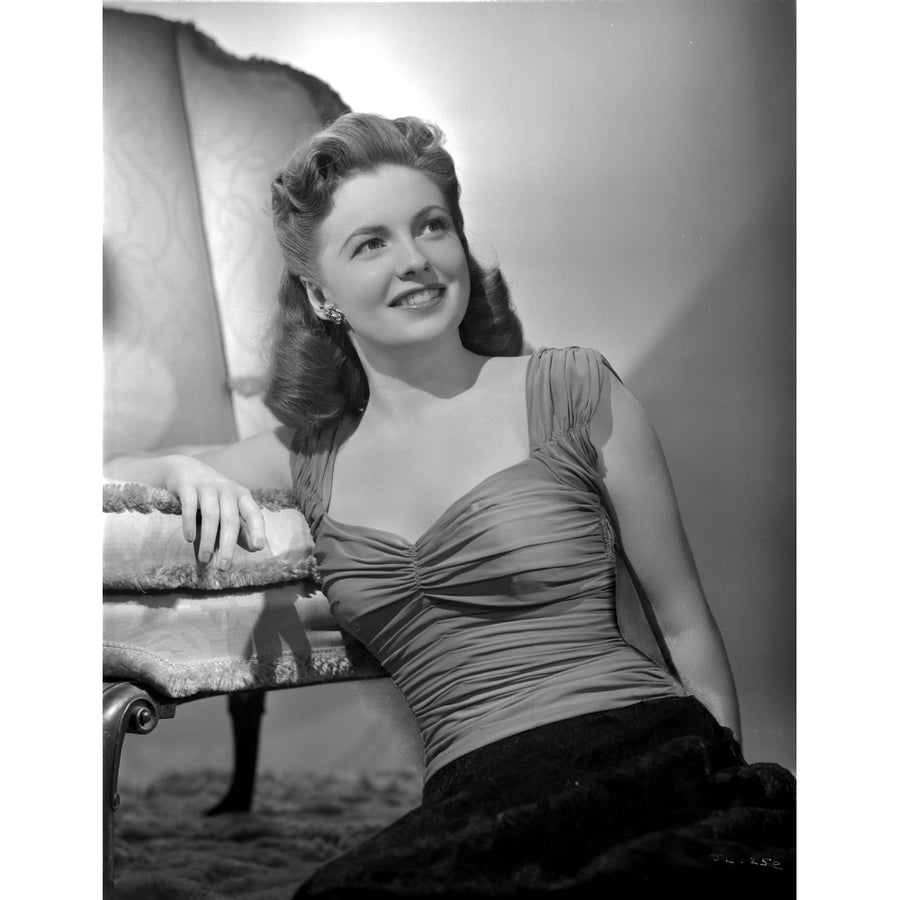 Joan Leslie on a Ruffled Top sitting on a Floor and smiling Photo Print Image 1