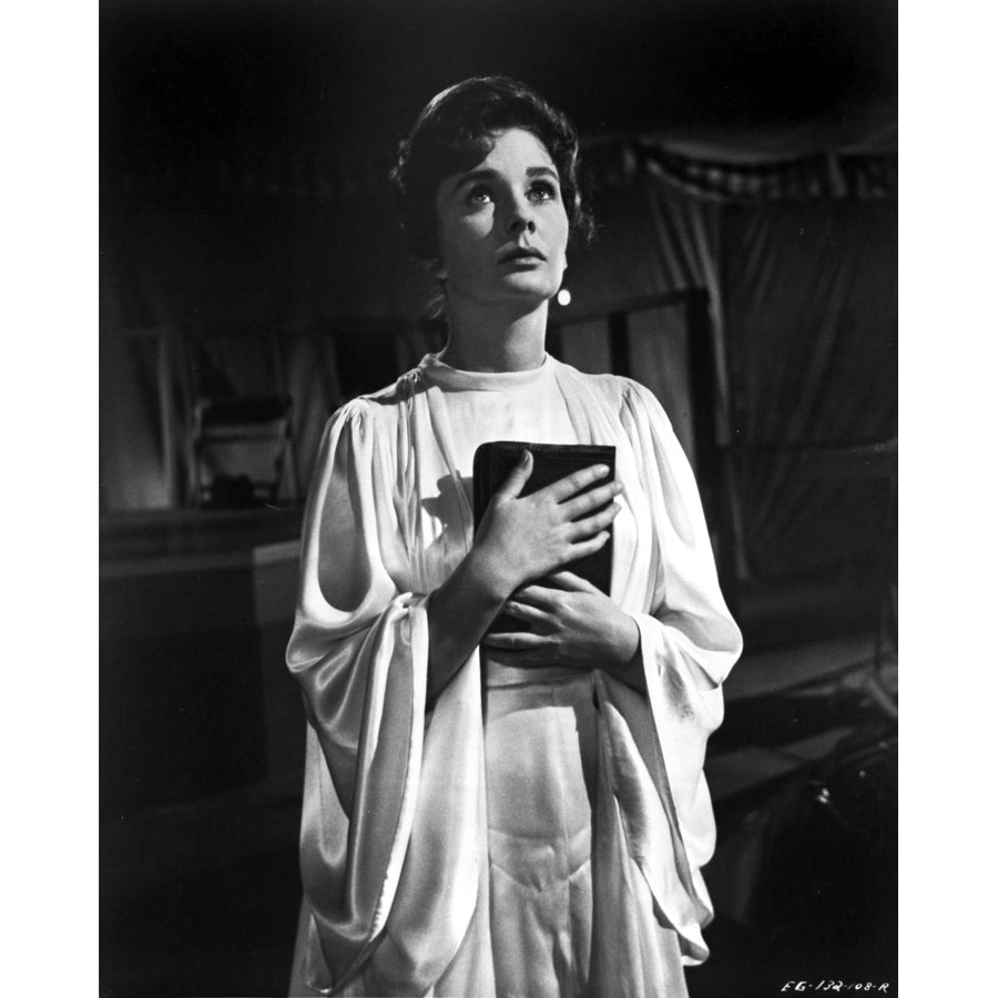 Jean Simmons Posed in White Butterfly Sleeve Silk Dress with Hands Together Holding a Black Book Photo Print Image 1