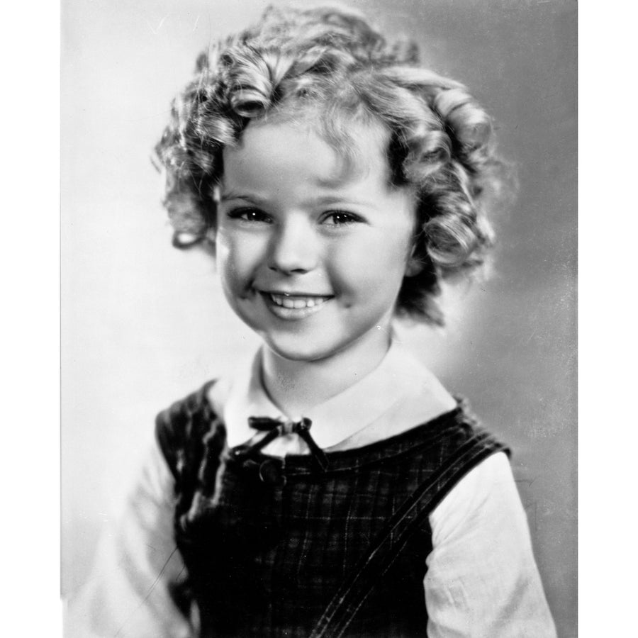 Shirley Temple wearing a White Blouse with a Black Gymslip Photo Print Image 1