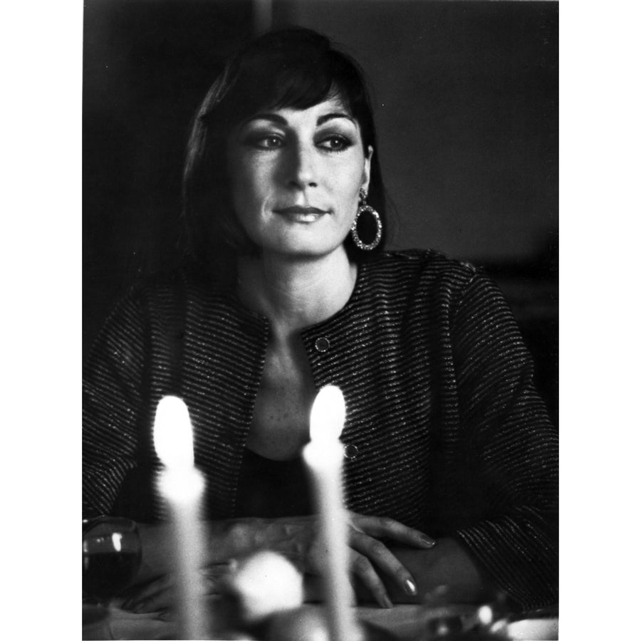 Anjelica Huston sitting at the Dining Table wearing a Loop Earring Portrait in Classic Photo Print Image 1