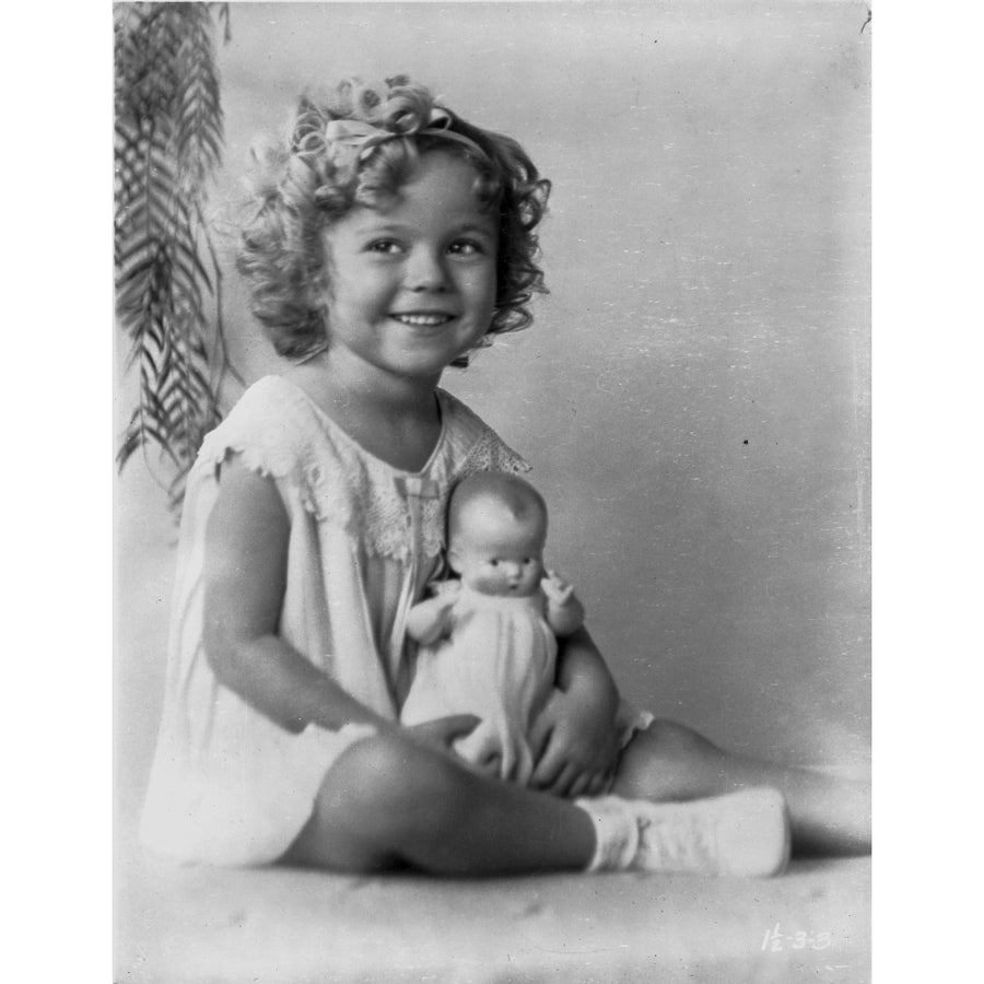 Shirley Temple wearing a House Dress and Holding a Doll in a Classic Portrait Photo Print Image 1