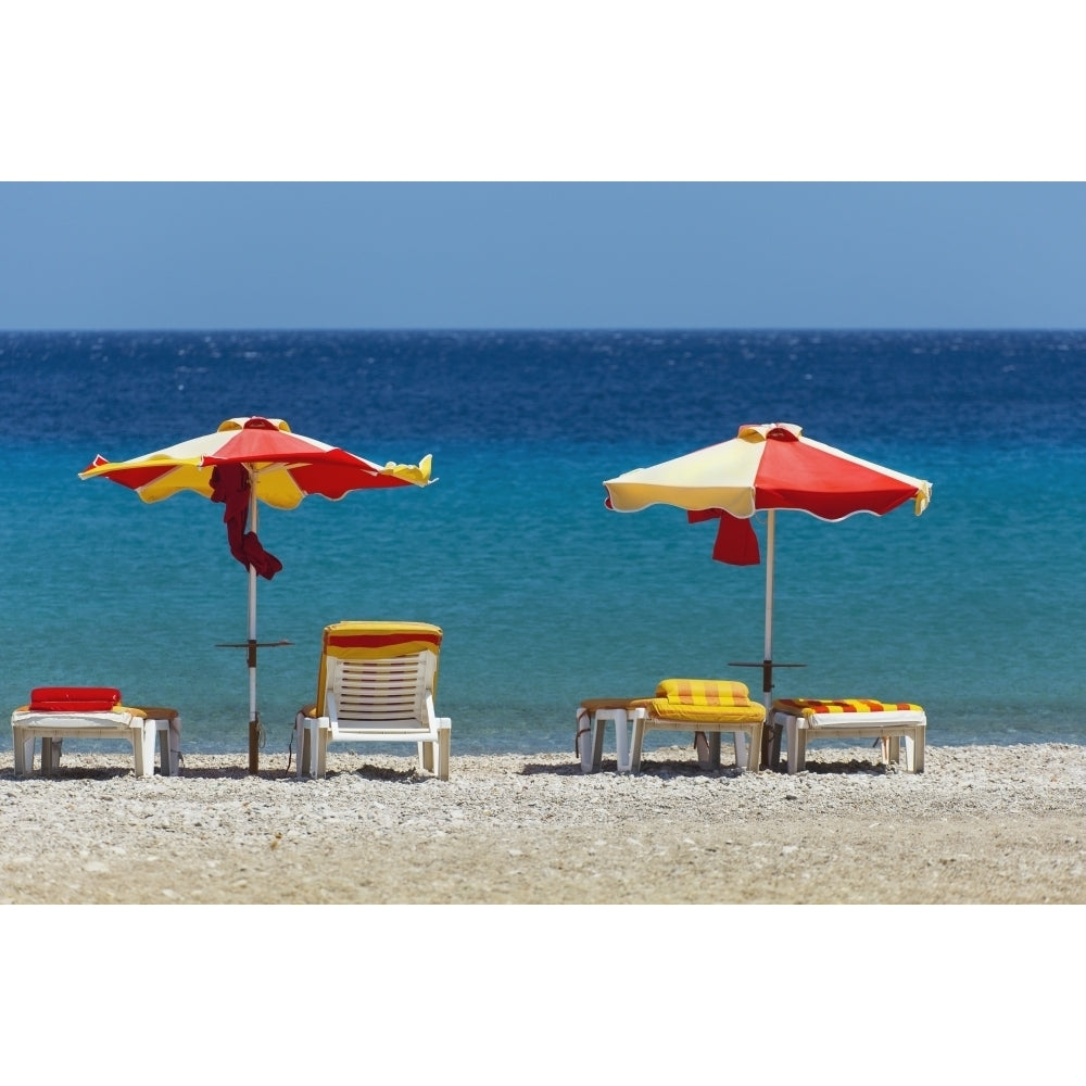 Umbrellas and beach chairs on a beach on the Island of Kos; Kefalos Greece Poster Print Image 1