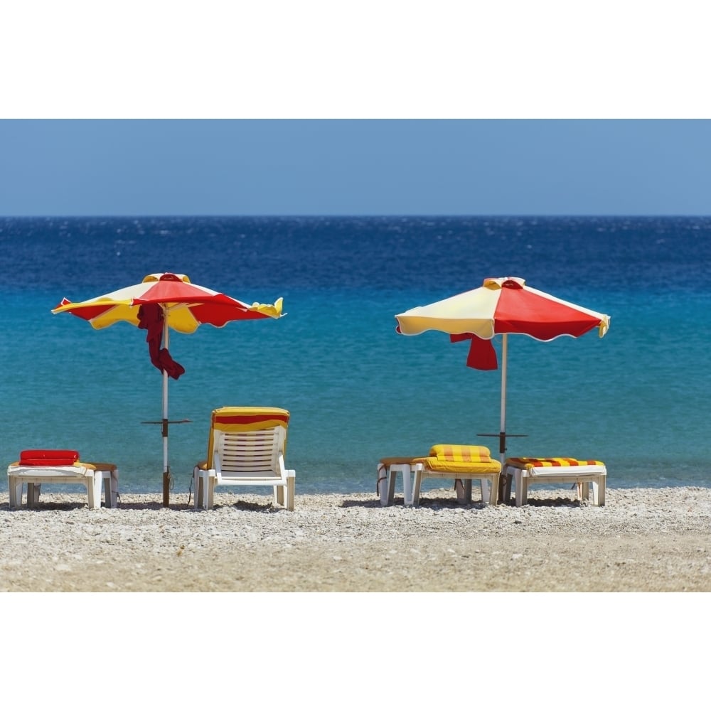 Umbrellas and beach chairs on a beach on the Island of Kos; Kefalos Greece Poster Print Image 1