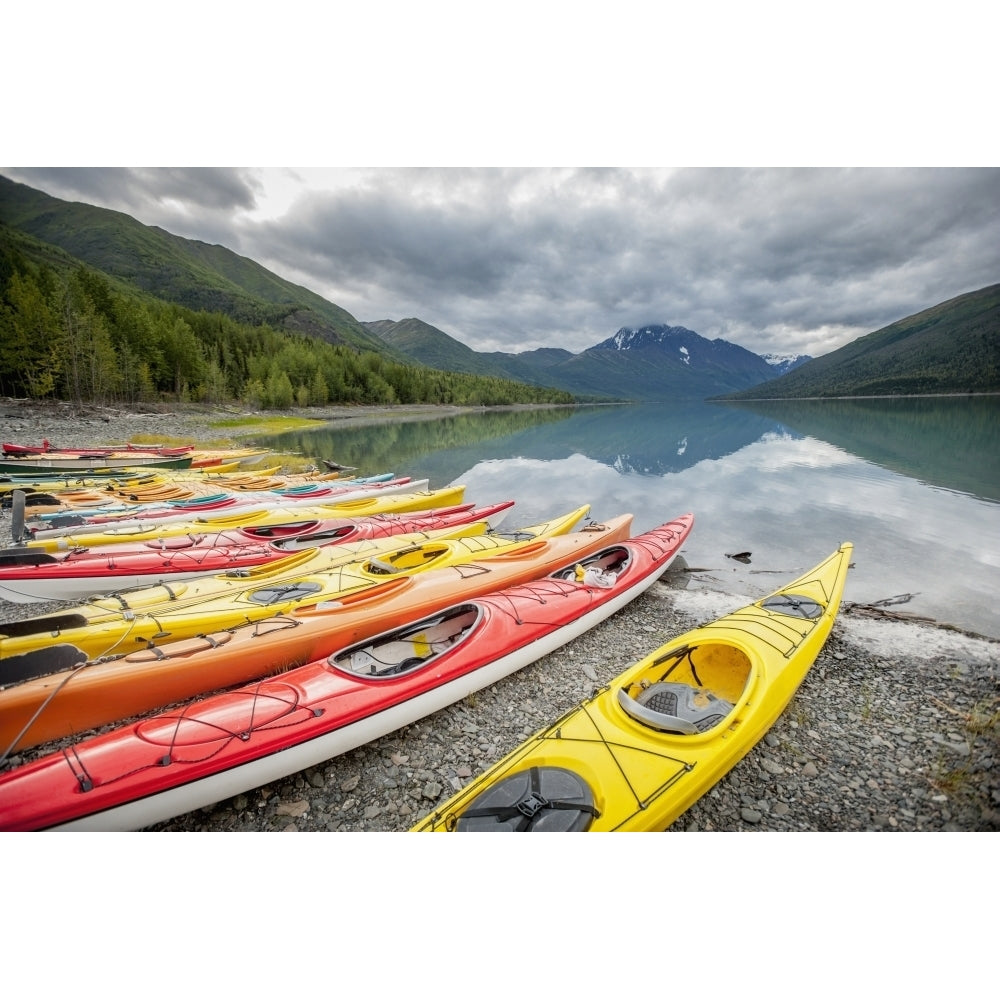 Kayaks in a row on shore at Eklutna Lake Chugach Mountains Southcentral Alaska. Poster Print Image 1