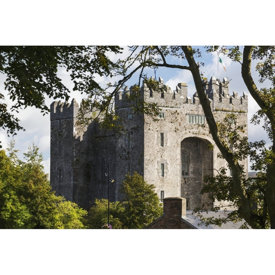 Stone castle framed within trees with clouds and blue sky; Bunratty County Clare Ireland Poster Print Image 1