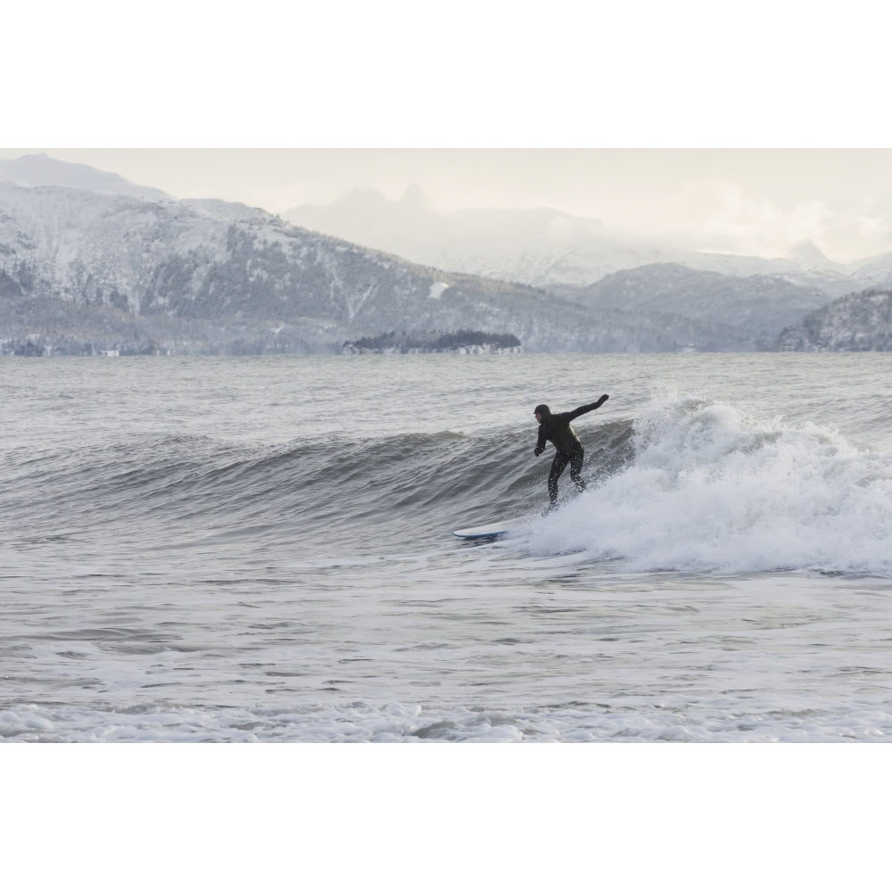 Person surfing in winter in Homer Kenai Peninsula Kachemak Bay Alaska. Poster Print by Scott Dickerson / Design Pics Image 1