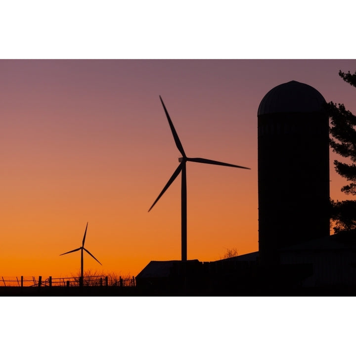 Elk Wind Energy Farm and a silo at sunrise near Edgewood; Iowa United States of America Poster Print Image 1