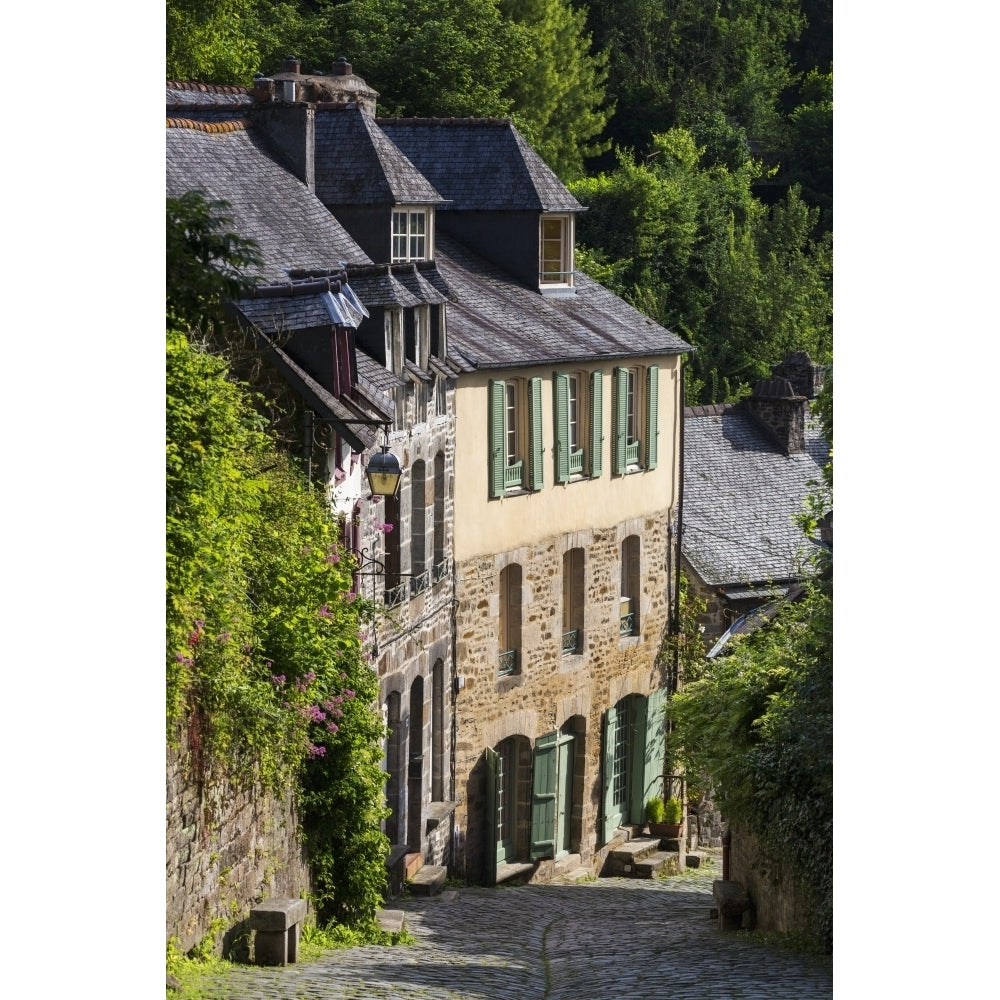 Old stone buildings with green shutters down a cobblestone road; Dinan Brittany France Poster Print Image 1