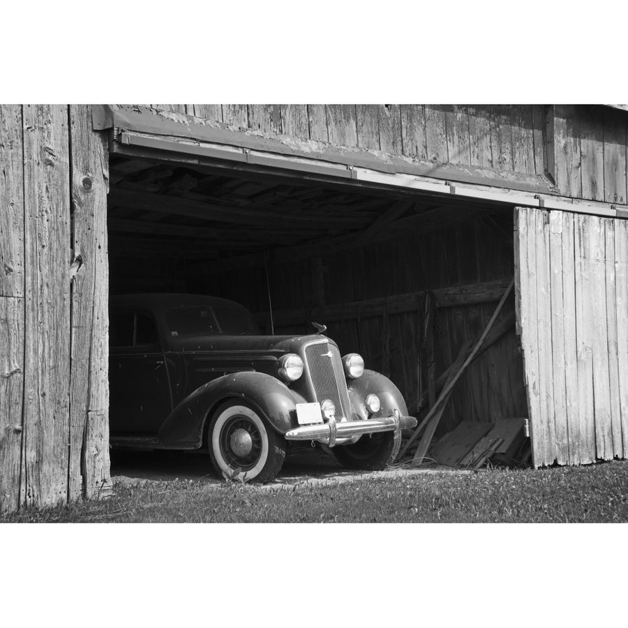 Black and white image of the front of an antique car inside a wooden barn; Frankford Ontario Canada Print Image 1