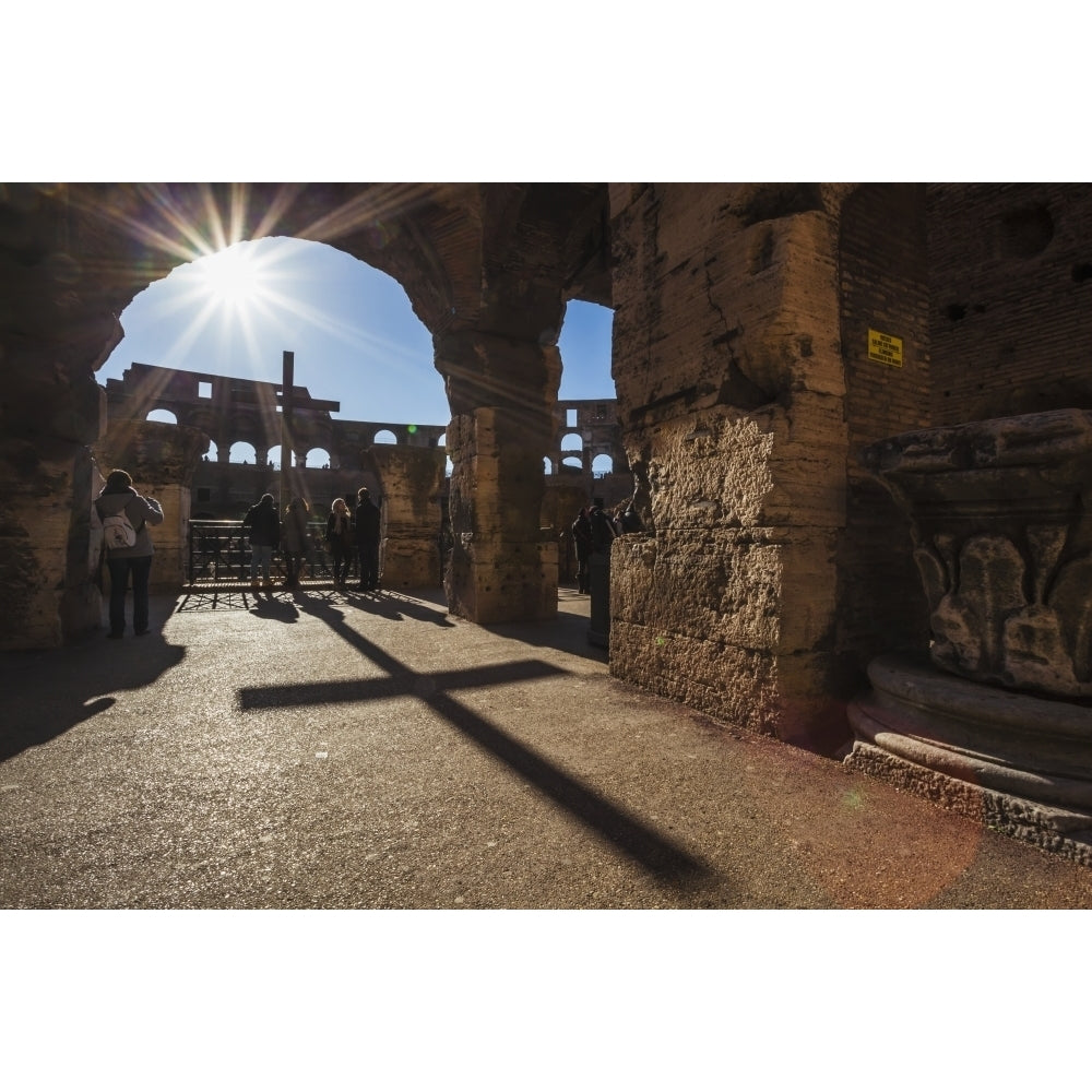 Sunburst through an archway at the Colosseum and a shadow of a cross; Rome Italy Poster Print Image 1