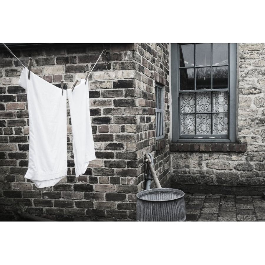 Stone walls of a house with laundry hanging to dry on the clothesline; Beamish Durham England Poster Print Image 1