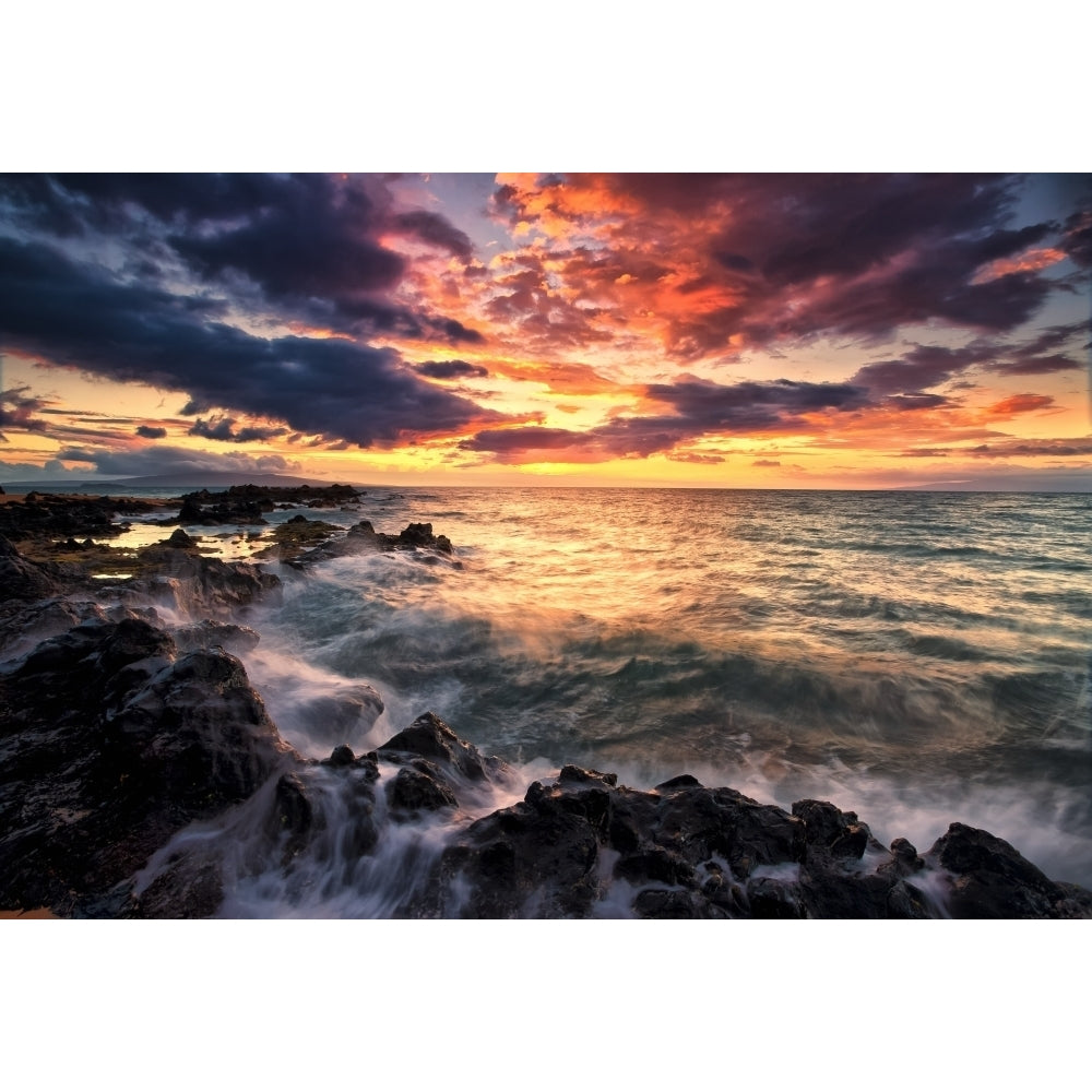 Dramatic colourful sky at sunset over the pacific ocean and the rugged coastline of a hawaiian island; Hawaii United St Image 1