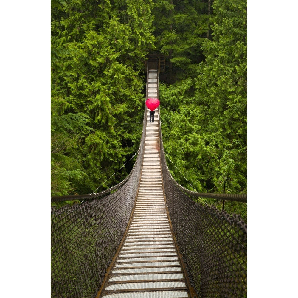 Woman With A Red Heart-Shaped Umbrella Crossing The Lynn Canyon Suspension Bridge North Vancouver; Vancouver British Image 1