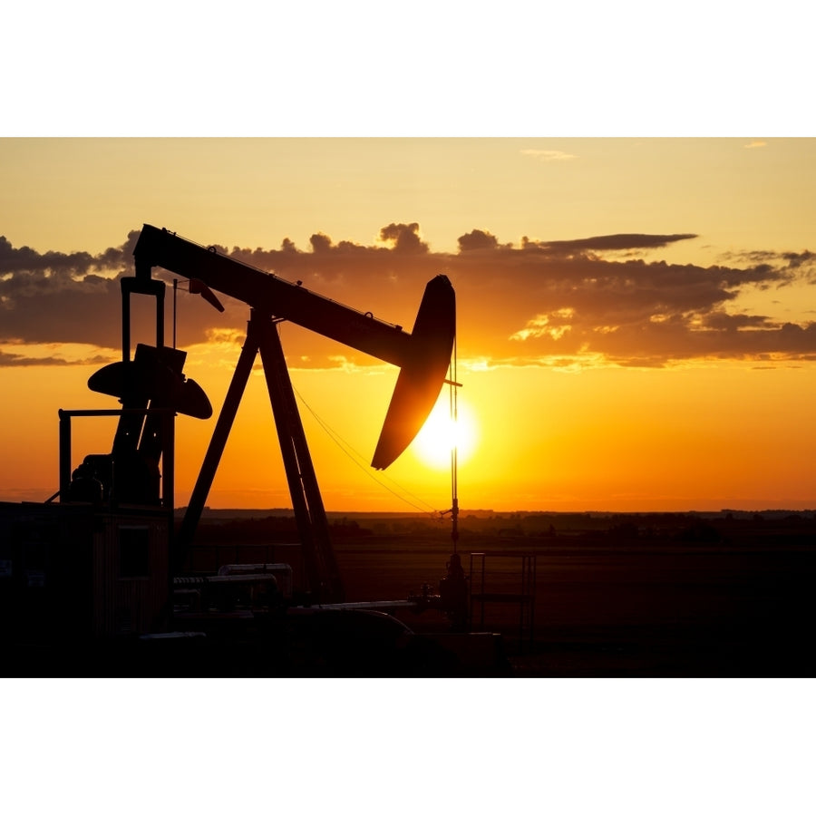 Silhouette Of A Pump Jack At Sunrise With A Colourful Orange Sun Clouds And Sky; Alberta Canada by Michael Interisano / Image 1