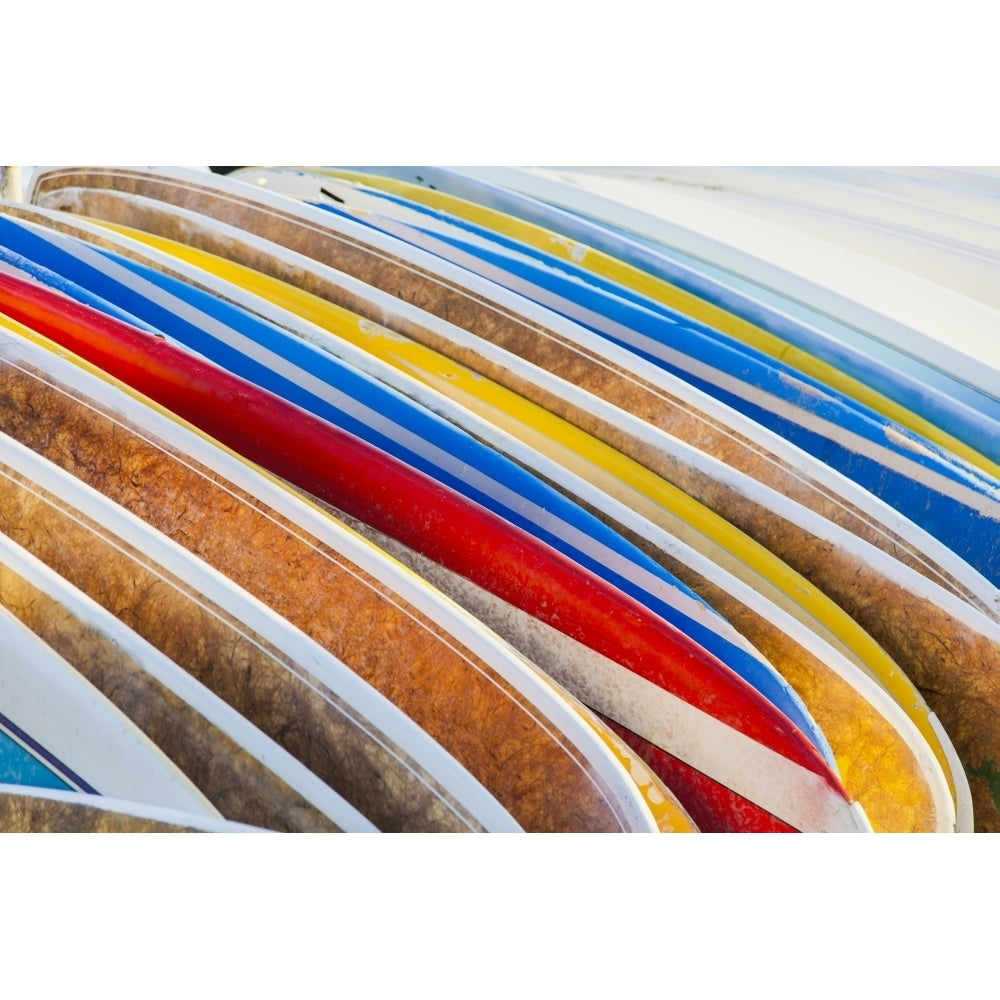 A stack of colourful longboard surfboards placed on the beach ; Waikiki Oahu Hawaii United States of America by Brandon Image 1