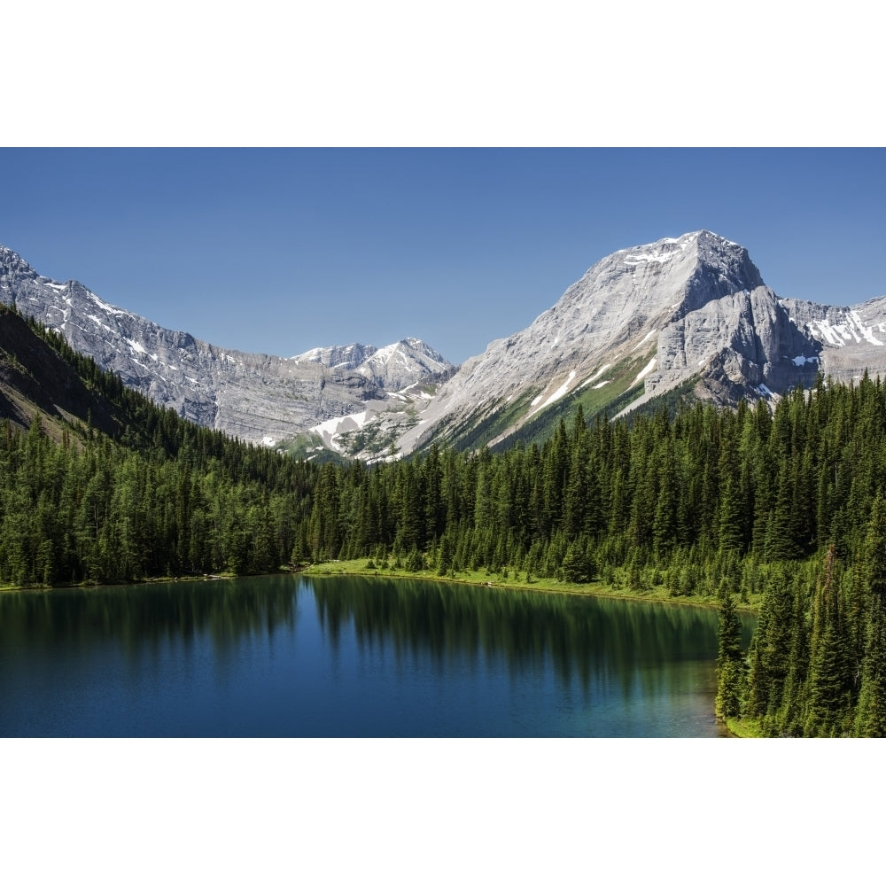 Colourful alpine lake surrounded by mountains and blue sky Spray Lake Provincial Park; Kananaskis Country Alberta Canada Image 1