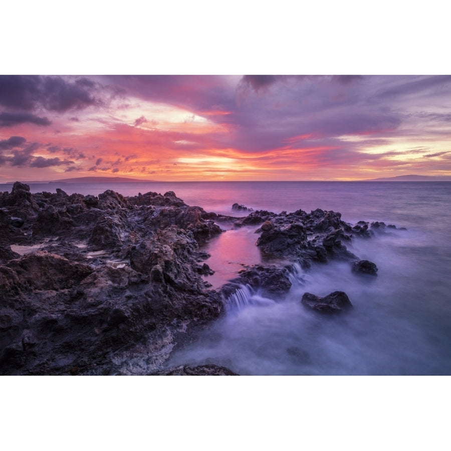 Dramatic sunset over the ocean with waterfalls along the rugged coastline; Wailea Maui Hawaii United States of America Image 1