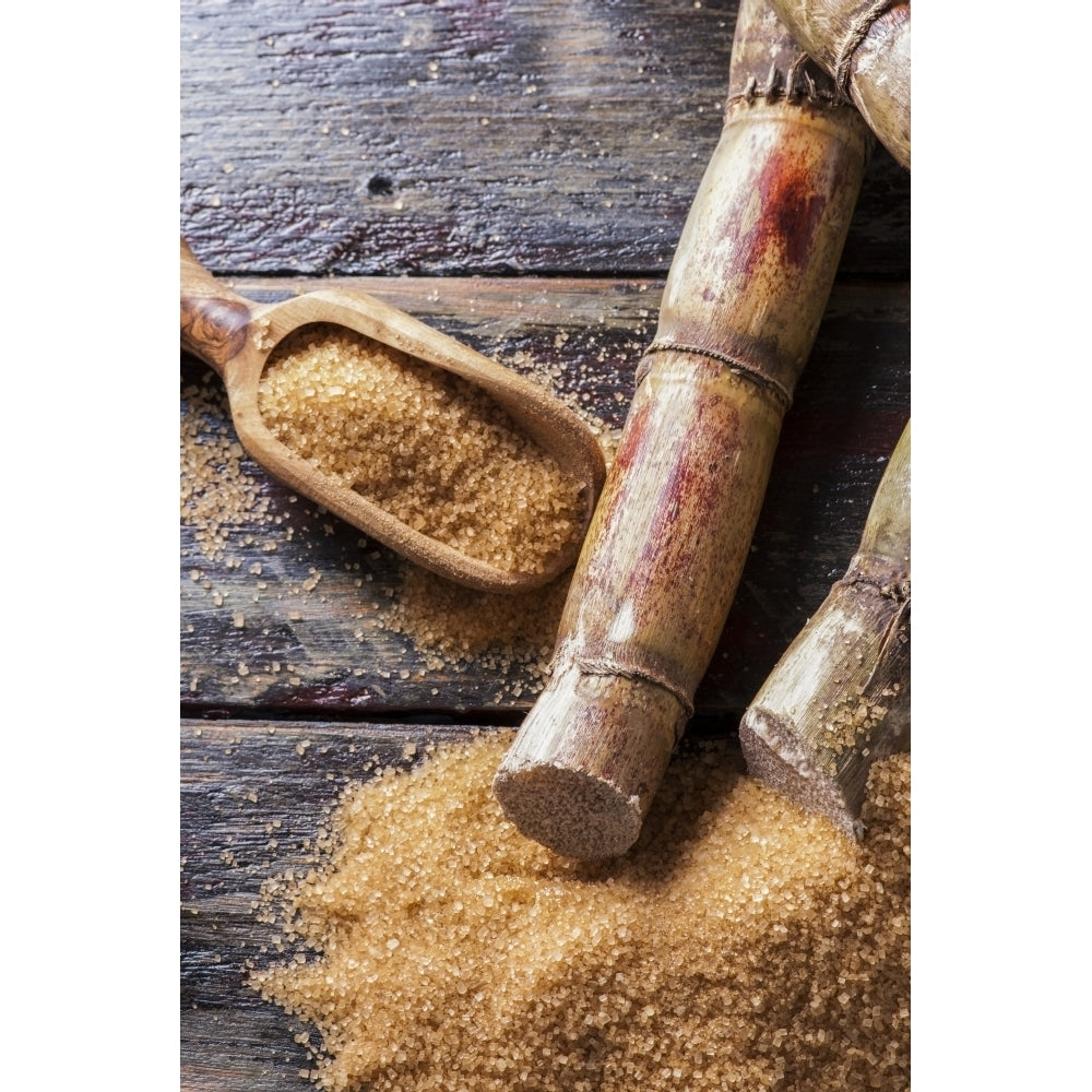 Raw sugar cane on a wooden surface and in a wooden scoop by Spyros Bourboulis / Design Pics Image 1